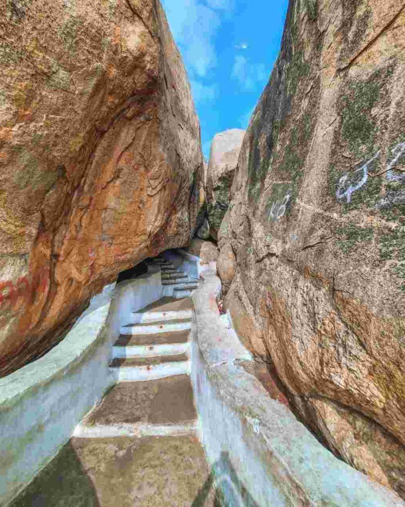 A pathway of steps leading between two large boulders
