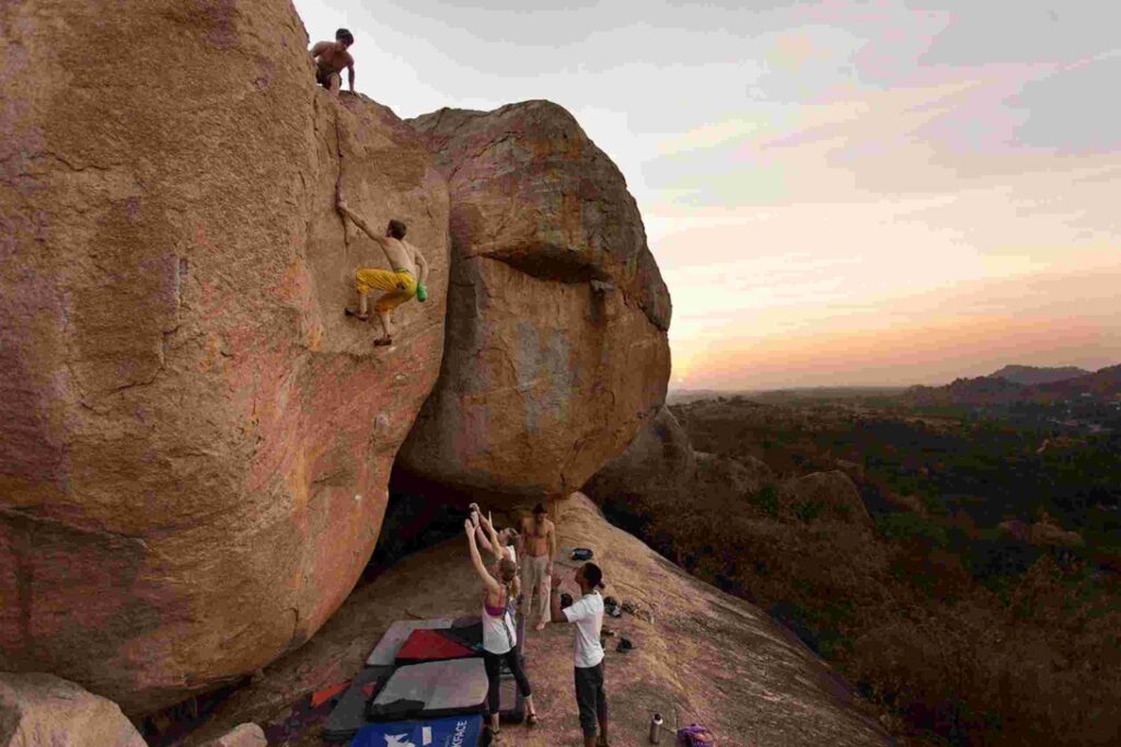 Climbers attempting rock climbing in Hampi