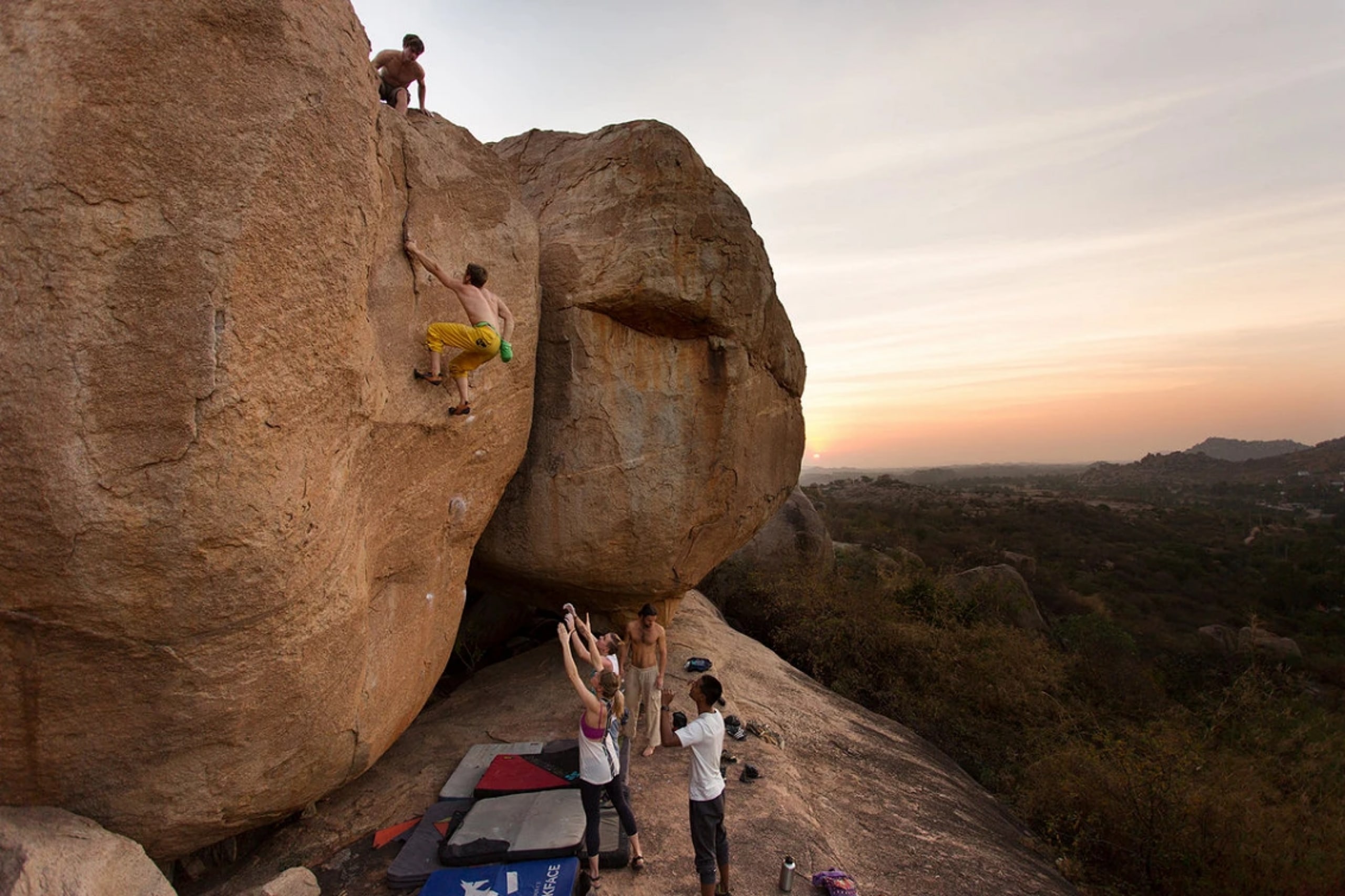 Climbers attempting rock climbing in Hampi