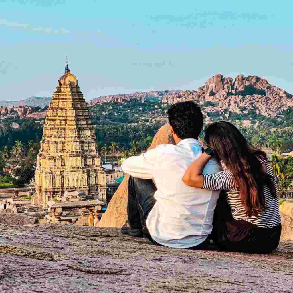 Couple viewing Virupaksh Temple tower from Hemakuta Hill