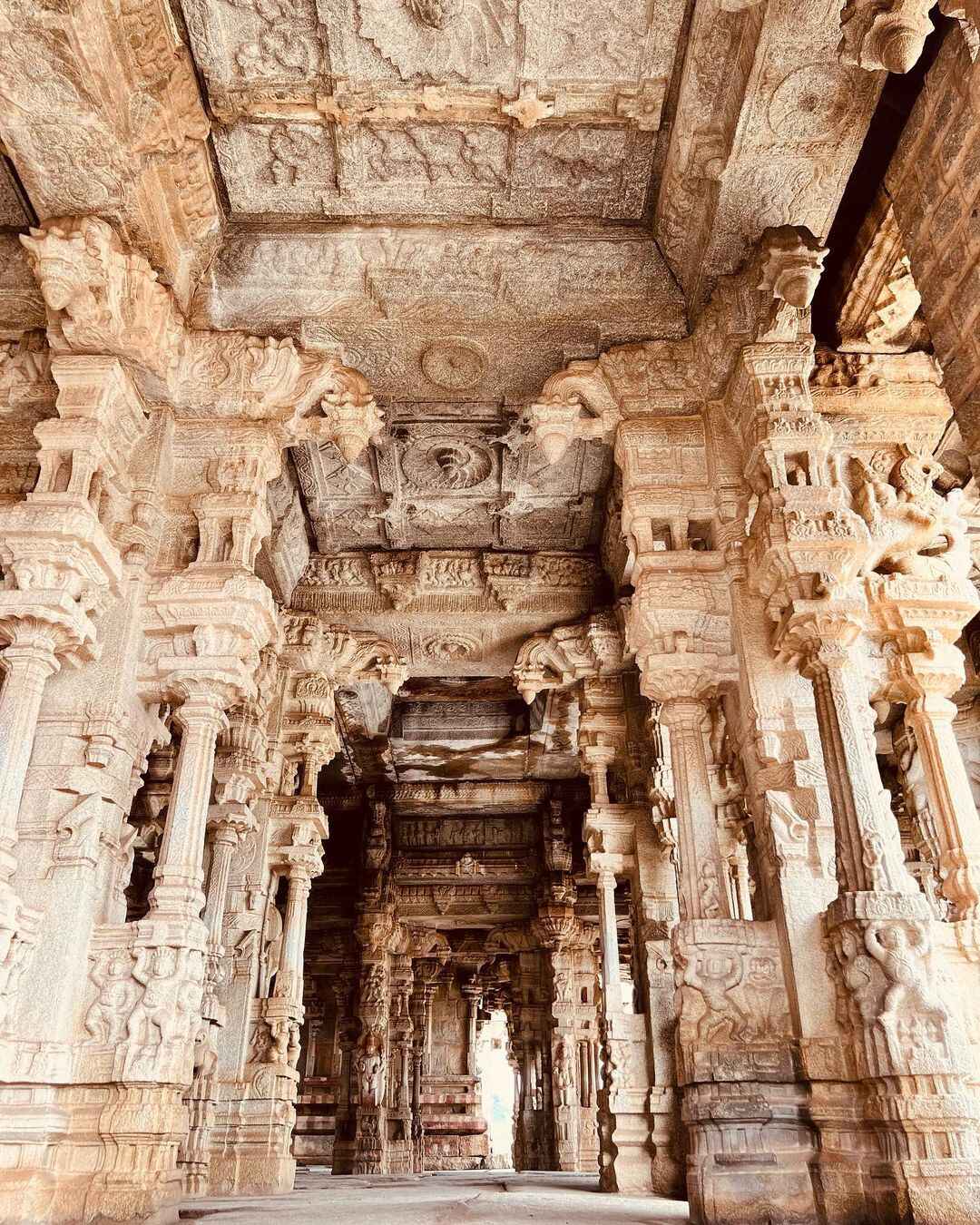 Large and tall, beautifully carved monolithic stone pillars in the Maha Mandapam