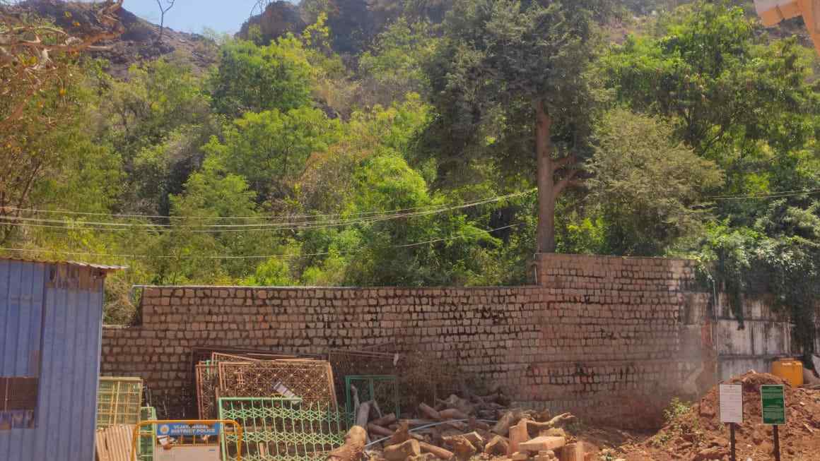 Massive Wall Dividing the Temple Grounds and Forested Hill