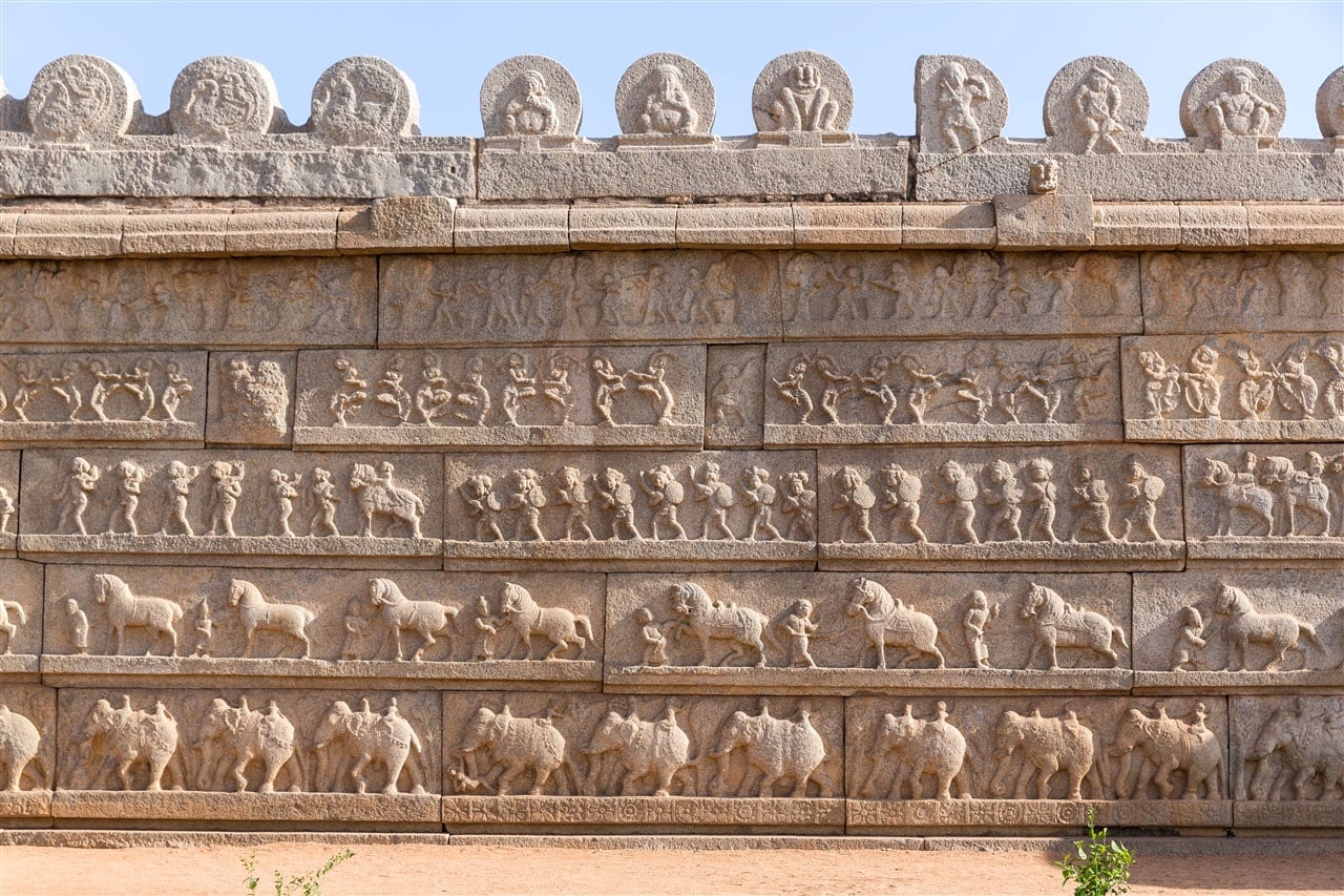 The outer wall of the Hazara Rama Temple is adorned with a captivating display of bas-reliefs depicting horses, elephants, camels, dancing girls, stick dances, musicians, and various other scenes