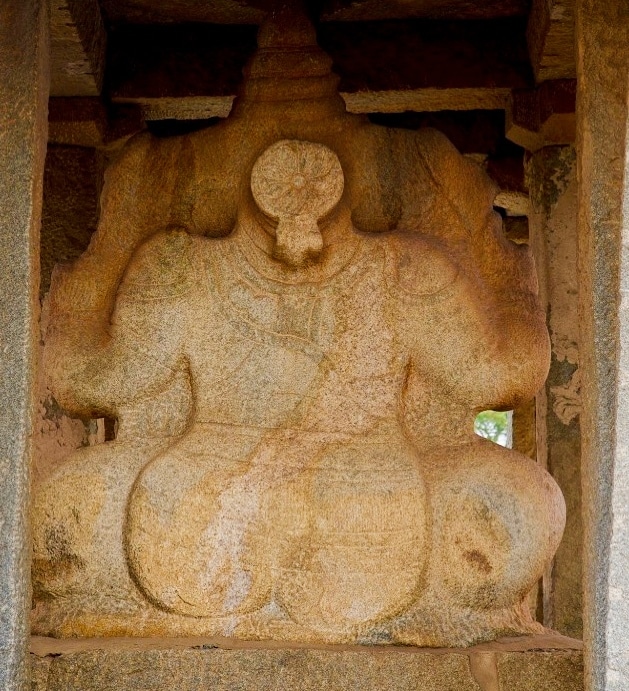 Parvati holds Ganesha in her lap behind the statue