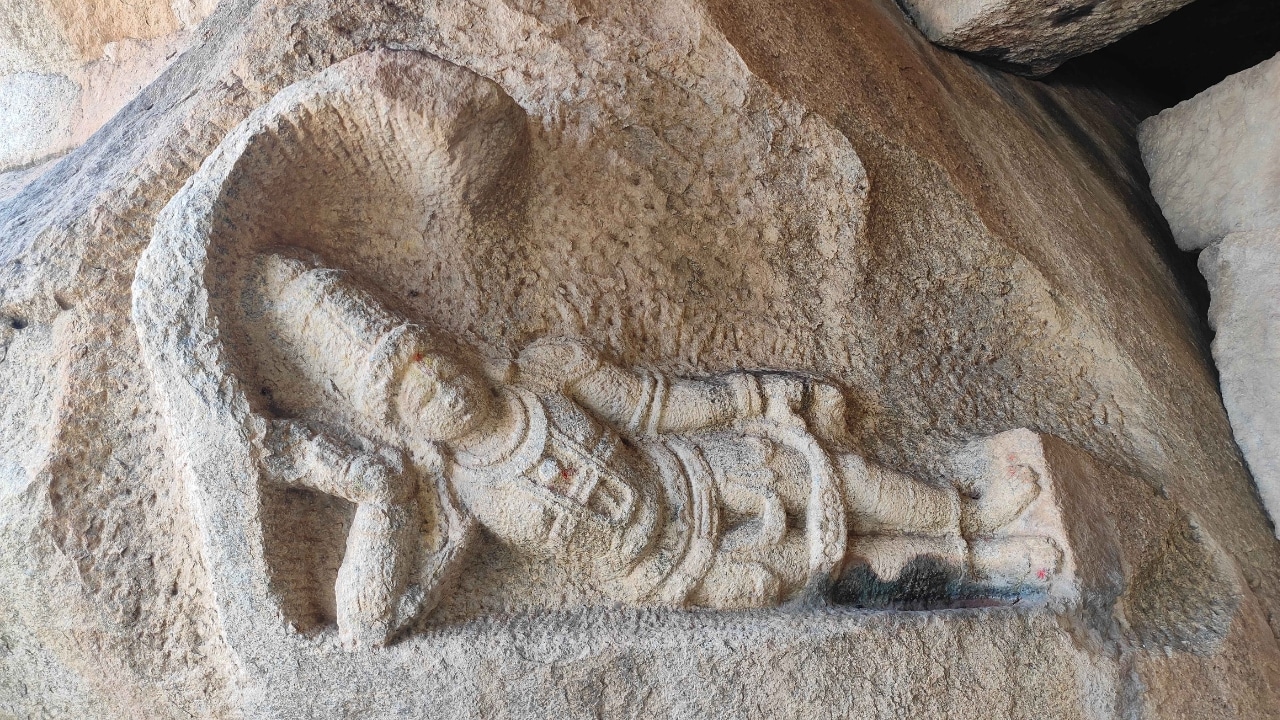 Sculpture of Ananta Padmanabha carved on rock in Vishnu temple, Hampi