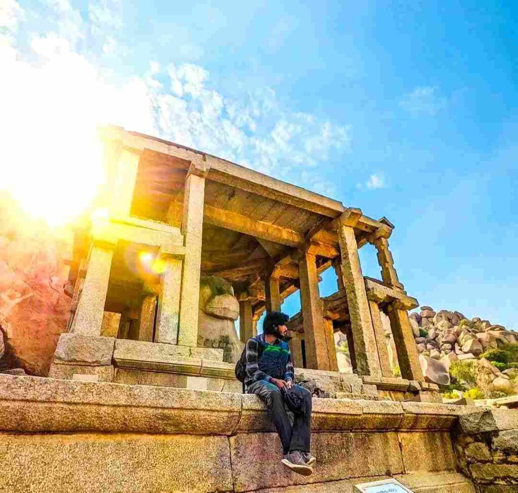 Sit peacefully by the Monolithic Bull statue and enjoy the peaceful atmosphere of Hampi Bazaar