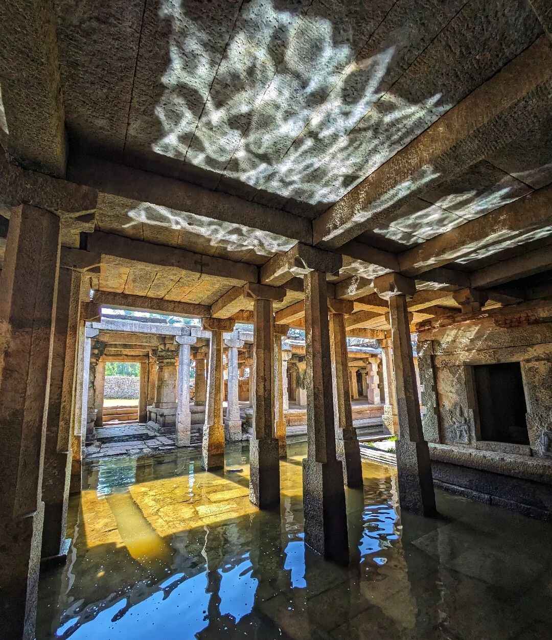 Sunlight dances on the ceiling of the Underground Shiva Temple, reflecting off the water and creating mesmerizing patterns