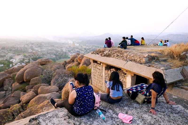 Tourists are enjoying the beautiful nature around them while waiting for the sunset