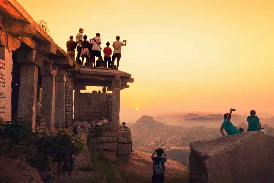 Visitors are climbing atop Veerabhadra Temple on Matanga Hill and watching the sunrise