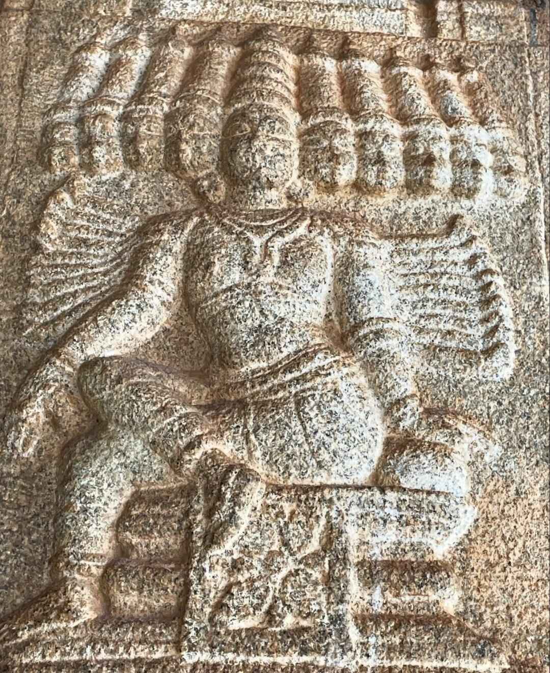 A small sculpture of ten-headed Ravanasura carved on a pillar